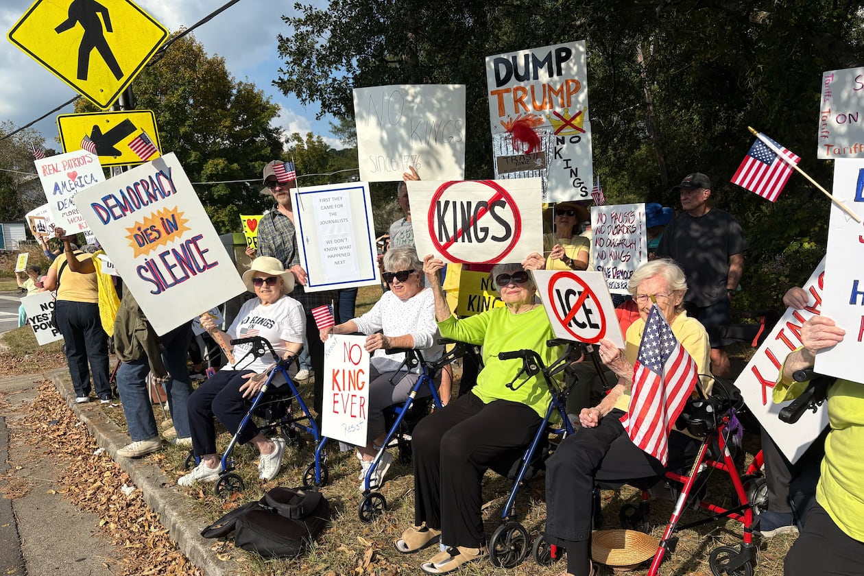 A group of DeKalb County seniors who call themselves "The Walker Brigade" lined Clairmont Road on Saturday afternoon to protest President Donald Trump and his administration's policies. 
(Shaddi Abusaid/AJC)