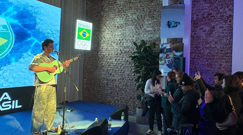 Brazilian snowboarder Pat Burgener plays a concert at the Brazil House, during the 2026 Winter Olympics, in Milan, Italy, Tuesday, Feb. 17, 2026. (AP Photo/Stefanie Dazio)