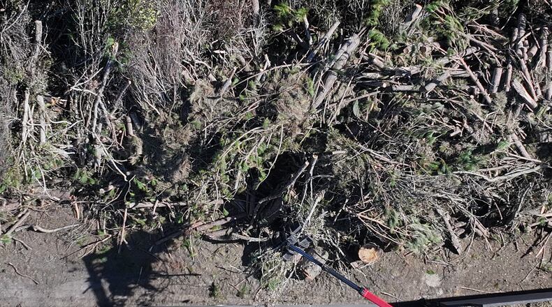 Workers with DebrisTech process debris in the aftermath of Hurricane Helene, Monday, October 21, 2024, in Hazelhurst. (Hyosub Shin / AJC)