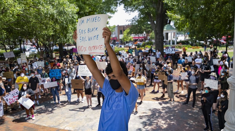 Walton High School student Joseph Fisher, 18, demonstrates on the square during a protest over the recent Minneapolis police killing of George Floyd, held Wednesday, June 3, 2020, in Marietta, Ga. JOHN AMIS FOR THE ATLANTA JOURNAL-CONSTITUTION