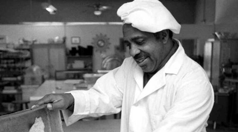 At Mary B. Jordan Catering, Windsor Jordan scrapes newly baked cornbread for Thanksgiving turkey dressing. —-This photo was made at 1971 Howell Mill Road N.W. at the office/kitchen of Mary B. Jordan Catering- in Atlanta, GA. Monday, November 25, 1996. (AJC Staff Photo/Dwight Ross, Jr.)