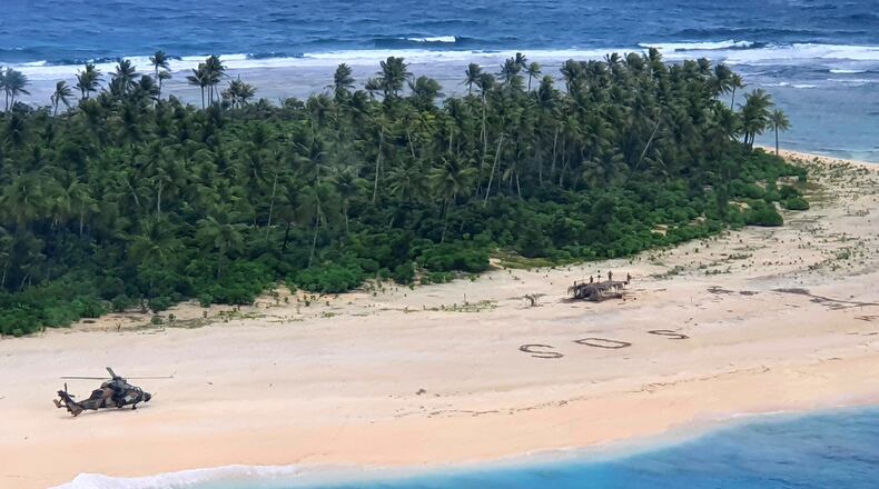 An Australian Army helicopter lands on Pikelot Island in the Federated States of Micronesia, where three men were found Sunday safe and healthy after missing for three days.
