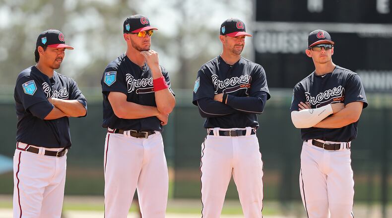 Catchers Kurt Suzuki (from left), Tyler Flowers, Chris Stewart, and Rob Brantley line up for instruction Tuesday.