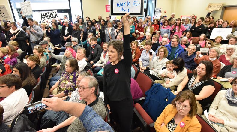 Protesters hold their signs and rally against the Trump administration during Open Office Day event at Greene County Government Office in Greensboro on Friday, February 10, 2017. Hundreds of protesters flocked to a "constituent service day" for U.S. Senators David Perdue and Johnny Isakson and Rep. Jody Hice in this east Georgia town, cheering as one speaker after another railed against the three Republicans and the Trump administration. HYOSUB SHIN / HSHIN@AJC.COM