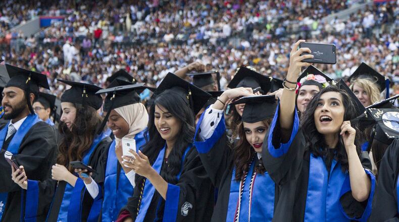 Georgia State University undergraduate students take part in the 2018 commencement ceremony at Georgia State Stadium in Atlanta on May 10, 2018. It has the largest enrollment of any university in Georgia, with about 53,000 students. A bill in the Georgia House of Representatives would allow all high school graduates, regardless of their immigration status, to pay in-state tuition at any public college or university in the state, with some conditions. AJC FILE PHOTO / REANN HUBER 2018