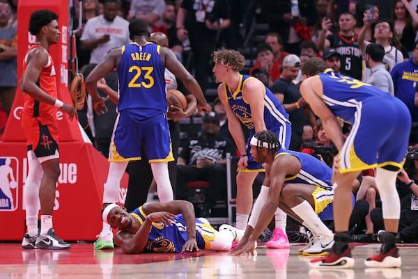 Golden State Warriors' Jimmy Butler III writhes in pain after injuring himself in 1st quarter against Houston Rockets in Game 2 of First Round of NBA Playoffs at Toyota Center in Houston, Texas on Wednesday, April 23, 2025. (Scott Strazzante/San Francisco Chronicle via AP)