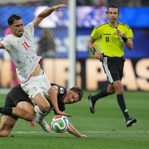 Iran's Ali Alipour (11) battles for the ball with New Zealand's Ryan Thomas (23) during the World Cup Group G soccer match between Iran and New Zealand in Inglewood, Calif., near Los Angeles, Monday, June 15, 2026. (AP Photo/Andre Penner)