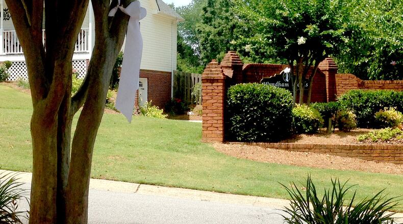 White ribbons adorn the mailboxes and entryway sign the in Wyndham Woods, where teacher Jenna Wall was shot to death last week. (Alexis Stevens/astevens@ajc.com)