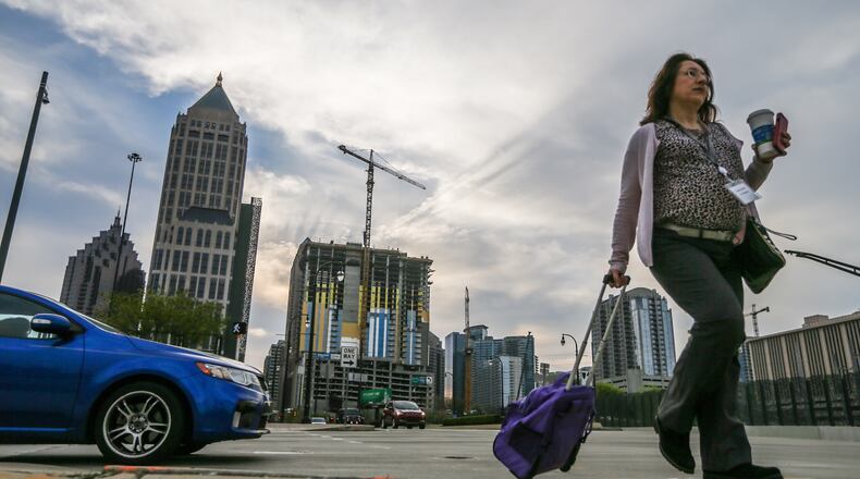 Sally Gilmore walks on 14th Street in downtown Atlanta. JOHN SPINK / JSPINK@AJC.COM