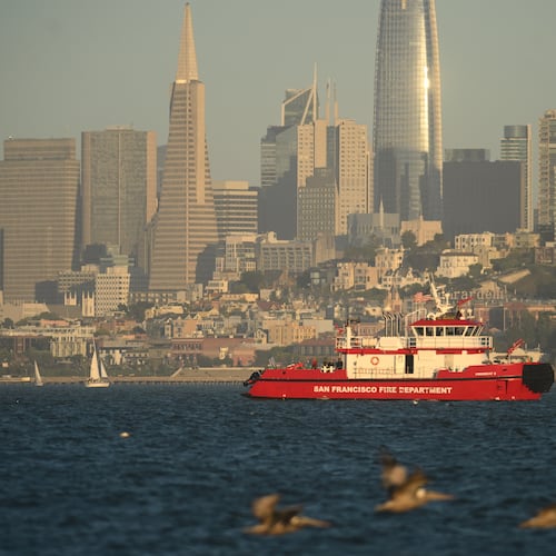 A San Francisco Fire Department vessel passes the city skyline while searching for missing victims after a boat accident near Alcatraz Island off San Francisco, Tuesday, July 14, 2026. (AP Photo/Noah Berger)