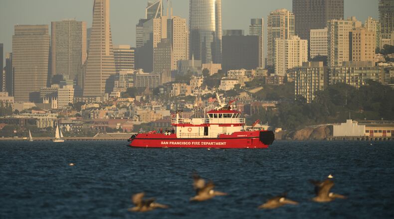A San Francisco Fire Department vessel passes the city skyline while searching for missing victims after a boat accident near Alcatraz Island off San Francisco, Tuesday, July 14, 2026. (AP Photo/Noah Berger)