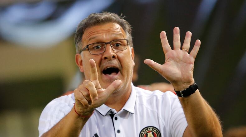 Atlanta United head coach Gerardo "Tata" Martino signals to his players in the second half of an MLS soccer match against the Columbus Crew Saturday, June 17, 2017, in Atlanta (AP Photo/John Bazemore)