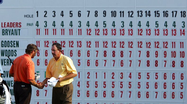 Retief Goosen, of South Africa, left, shakes hands with leader Bart Bryant after they finished the third round of the Tour Championship at East Lake Golf Club in Atlanta Saturday, Nov. 5, 2005. (AP Photo/John Bazemore)