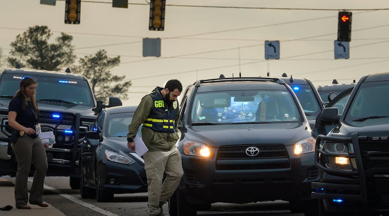 A GBI agent investigates the scene of an officer-involved shooting in Cobb County. The shooting occurred on Chastain Road over I-75.