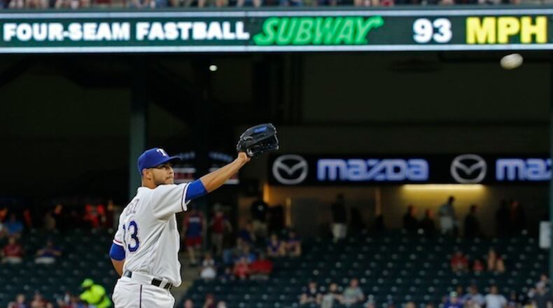 Texas Rangers starting pitcher Martin Perez (33) with the new pitch sign above his head (in right field) during a game against the Seattle Mariners on Tuesday, April 5, 2016, at Globe Life Park in Arlington, Texas. Real-time detailed pitch information, including type and velocity, is now standard at every park. The same data is also sent to the MLB At-Bat application used by fans on their computers, tablets and smartphones. (Paul Moseley/Fort Worth Star-Telegram/TNS)