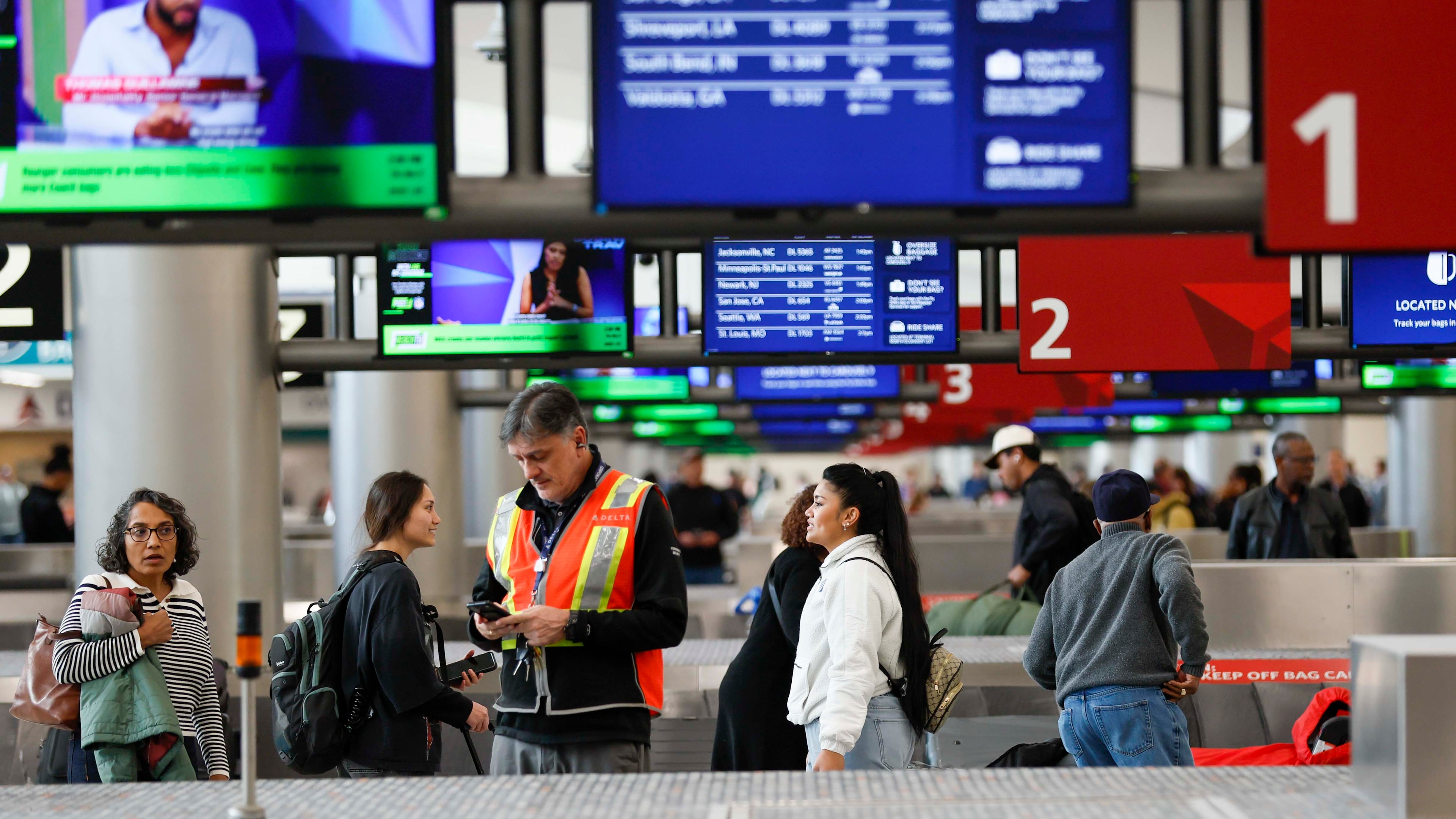 Travelers walk around baggage claim in the South Terminal at Hartsfield-Jackson Atlanta International Airport on Thursday, Nov. 6, 2025. The Federal Aviation Administration has ordered airlines to cut traffic across 40 of the nation’s busiest airports starting Friday. (Miguel Martinez/AJC)