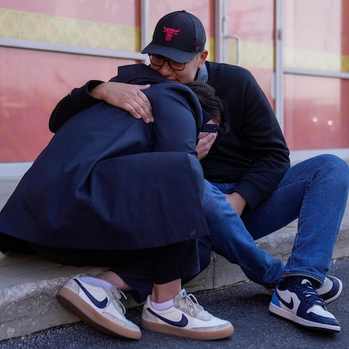 Maria Guzman, left, and Sergio Rocha, parents of young children, comfort each other outside of Rayito de Sol Spanish Immersion Early Learning Center after federal immigration agents took a daycare teacher Wednesday, Nov. 5, 2025, in Chicago. (AP Photo/Erin Hooley)