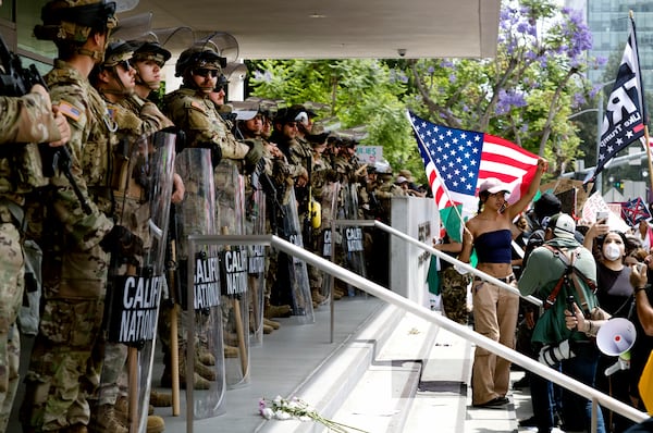 Protesters stand off against California National Guard soldiers at the Federal Building in downtown Los Angeles during a "No Kings" protest on Saturday, June 14, 2025. (AP Photo/Richard Vogel)