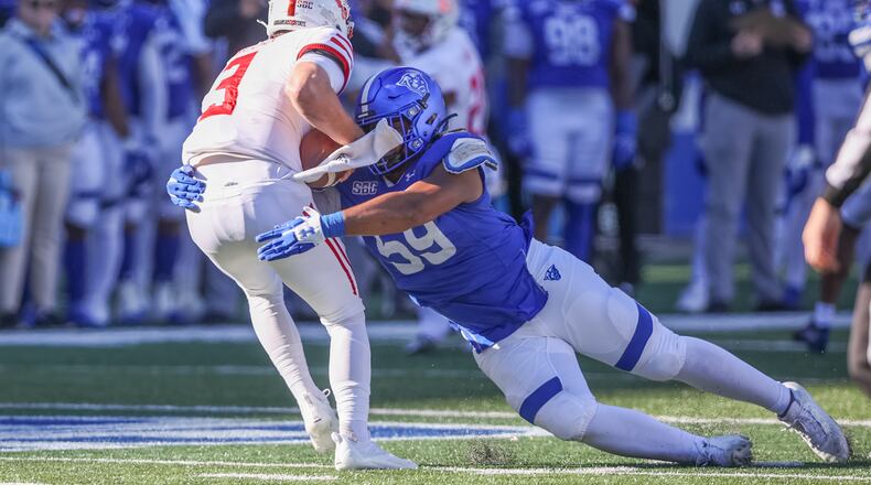 Georgia State's Thomas Gore brings down Arkansas State quarterback Layne Hatcher in a game in 2021. Gore had two sacks during that game. (Photo - Ben Ennis)