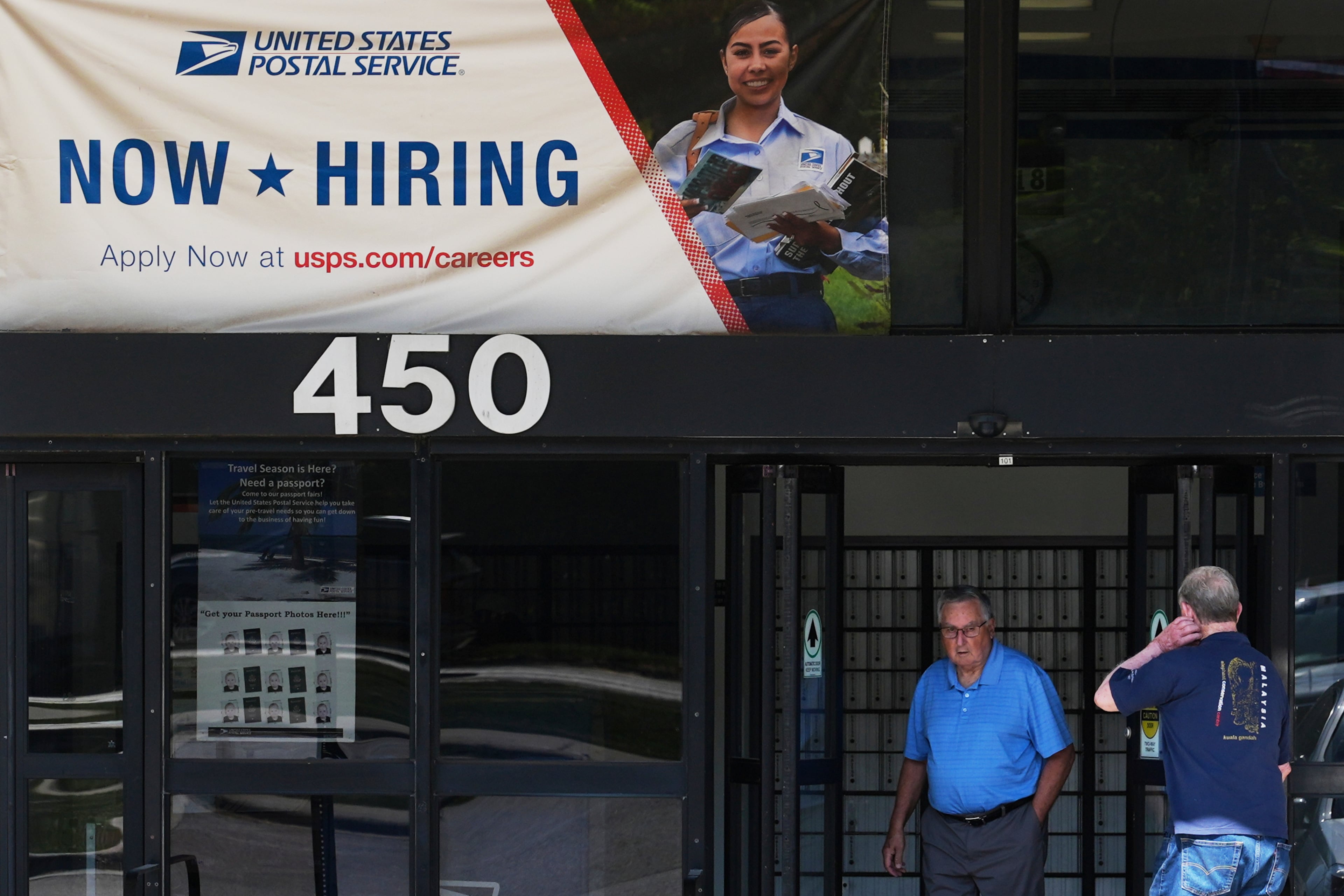 A hiring sign is displayed last month at a post office in Schaumburg, Ill.