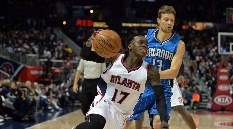 Hawks’ Dennis Schroder ldrives past the Magic’s Luke Ridnour during a recent game in Atlanta. Brant Sanderlin / bsanderlin@ajc.com
