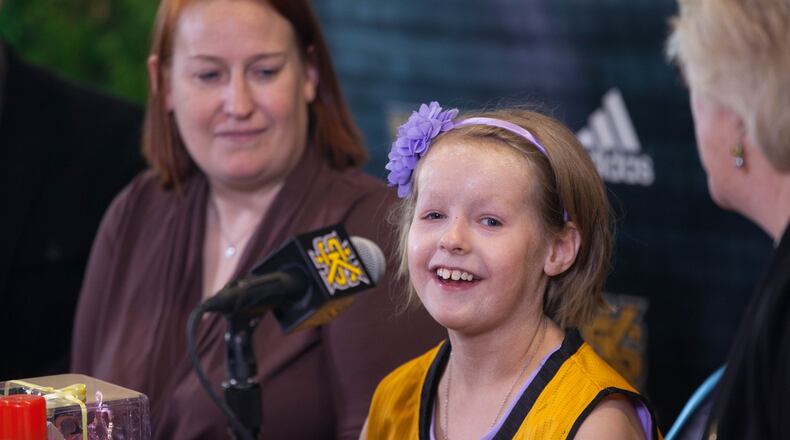 Cate Zavitz, 8, center, talks to the media while sitting with her mother, Sam Zavitz, left, and KSU women’s basketball coach Agnus Berenato at Kennesaw State University, Thursday, Jan. 26, 2017, in Kennesaw, Ga. The Kennesaw State women’s basketball team adopted Zavitz, who has a skin disease, through the Team IMPACT organization. BRANDEN CAMP/SPECIAL
