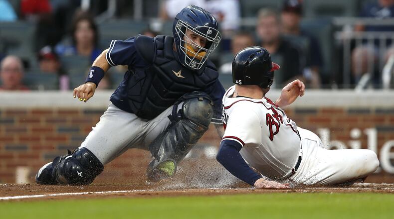 Freddie Freeman is tagged out by Padres catcher Raffy Lopez in the third inning of Friday's game at SunTrust Park. (Photo by Mike Zarrilli/Getty Images)