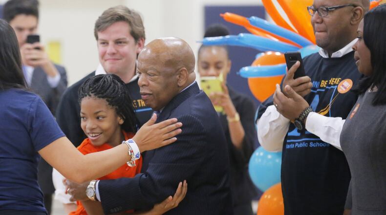 John Lewis gave hugs for the first day of school at the John Lewis Invictus Academy. Lewis, a longtime congressman from Atlanta and civil rights activist, died in 2020. AJC FILE PHOTO.