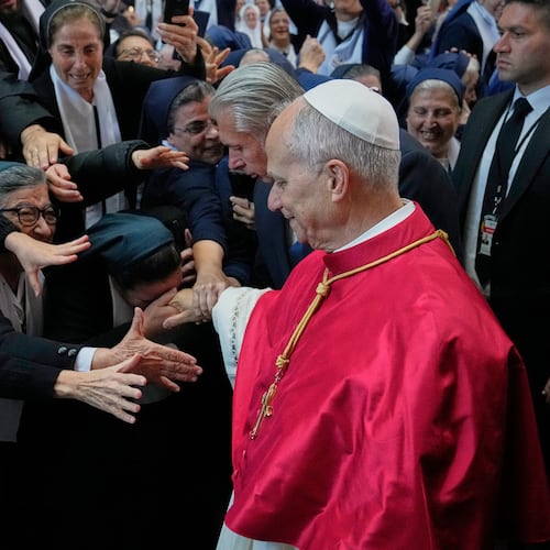A group of nuns reach out to Pope Leo XIV as he arrives to the Catholic basilica of Harissa, Lebanon Monday, Dec. 1, 2025. (AP Photo/Hussein Malla)