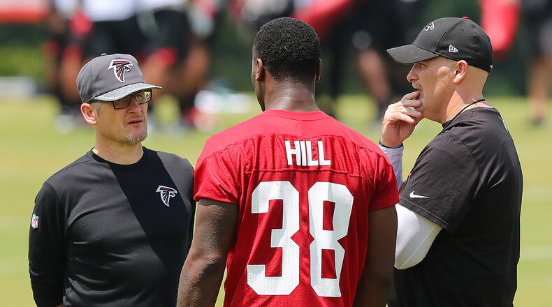 May 12, 2017, Flowery Branch: Falcons head coach Dan Quinn and General Manager Thomas Dimitroff talk with rookie running back Brian Hill, Wyoming, during rookie mini-camp on Friday, May 12, 2017, in Flowery Branch. Curtis Compton/ccompton@ajc.com