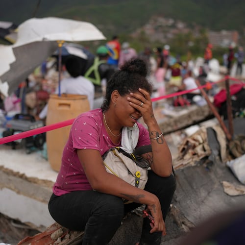 Khaterine Roa cries as members of the Los Angeles County Fire Department search for survivors at a building that collapsed during the earthquakes that struck La Guaira, Venezuela, Tuesday, June 30, 2026. (AP Photo/Matias Delacroix)