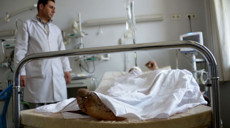 A wounded Afghan National Army soldier lies on a bed in the ward of a hospital in Mazar-i-Sharif on Friday as he receives treatment following an attack that targeted an army compound in the northern Afghan province of Balkh.More than 100 Afghan soldiers have been killed and wounded in a coordinated Taliban attack on an army base in northern Afghanistan, the country's defense ministry said.