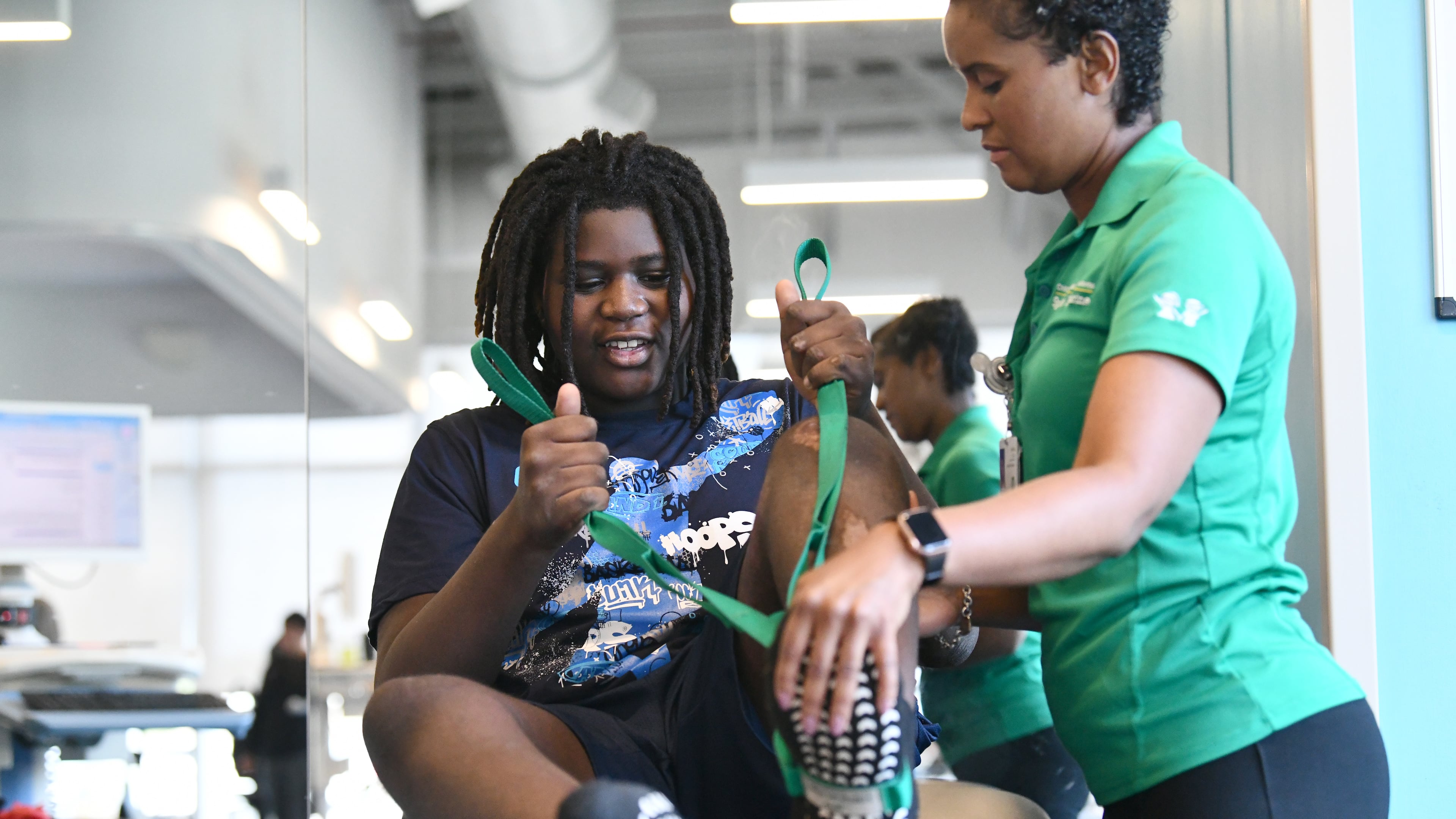 Preston Veal, 12, undergoes his first physical therapy appointment with Anzika Tuliva at Children's Healthcare of Atlanta Orthopedics and Sports Medicine on July 24. Preston was struck by a cargo van June 23. (Hyosub Shin/AJC)