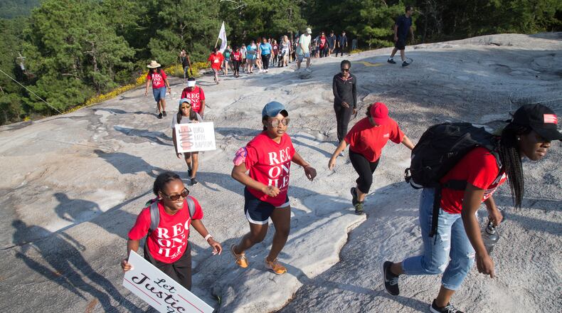 Participants in a racial reconciliation event at Stone Mountain on Saturday make their way to the top of the edifice. STEVE SCHAEFER / SPECIAL TO THE AJC