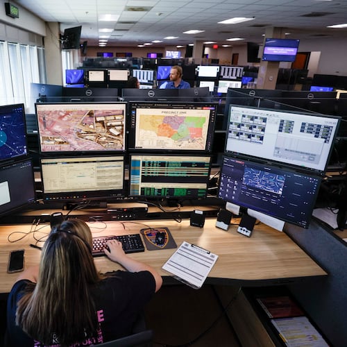 Emergency Communication Officer Julianna Shetterly is seen operating eight screens during her shift on Thursday, October 2, 2025. In August, the Cobb County 911 call center upgraded its systems with new technology, which includes the ability to receive video feeds from callers and utilize GIS to locate them. (Miguel Martinez/ AJC)