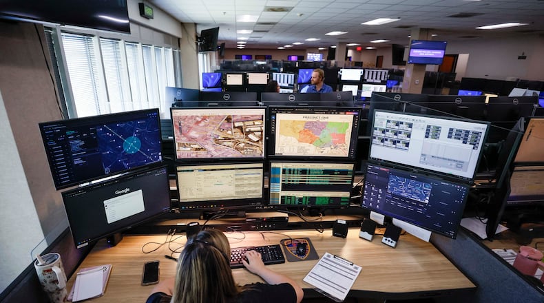 Emergency Communication Officer Julianna Shetterly is seen operating eight screens during her shift on Thursday, October 2, 2025. In August, the Cobb County 911 call center upgraded its systems with new technology, which includes the ability to receive video feeds from callers and utilize GIS to locate them. (Miguel Martinez/ AJC)