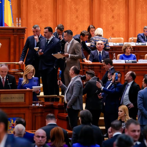 Romanian Prime Minister Ilie Bolojan, centre row third from right, sits as lawmakers vote during a no confidence vote in Bucharest, Romania, Tuesday, May 5, 2026. (AP Photo/Vadim Ghirda)
