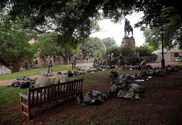 Virginia National Guard members wait to be deployed in August 2018 in Charlottesville, Virginia. Virginia’s highest court ruled Thursday that the city of Charlottesville can take down two statues of Confederate generals, including one of Robert E. Lee and the other of Stonewall Jackson, that became the focus of a violent white nationalist rally in 2017. (Photo by Win McNamee/file photo)