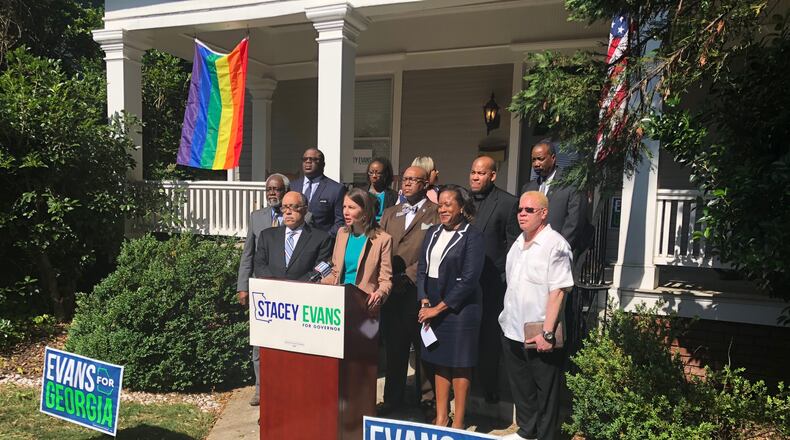 Democrat Stacey Evans is flanked by supporters at her campaign headquarters. AJC/Greg Bluestein