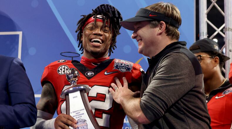 Georgia head coach Kirby Smart celebrates with defensive MVP defensive back Javon Bullard after Georgia’s 42-41 win against Ohio State in the Peach Bowl Playoff Semifinal, at Mercedes-Benz Stadium, Sat., Dec. 31, 2022, in Atlanta. (Jason Getz / Jason.Getz@ajc.com)