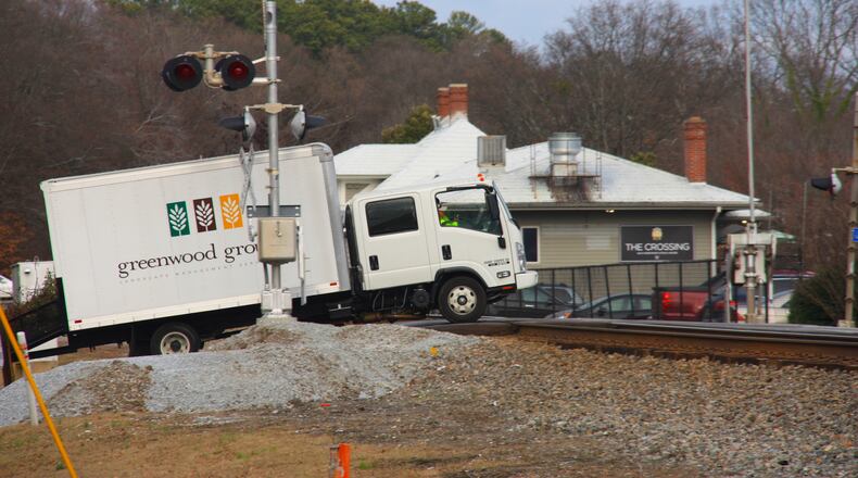 Steep incline at this railroad intersection in downtown Norcross has resulted in numerous vehicles stuck on the tracks, two in recent years resulted in train collisions. Photo by Karen Huppertz for the AJC