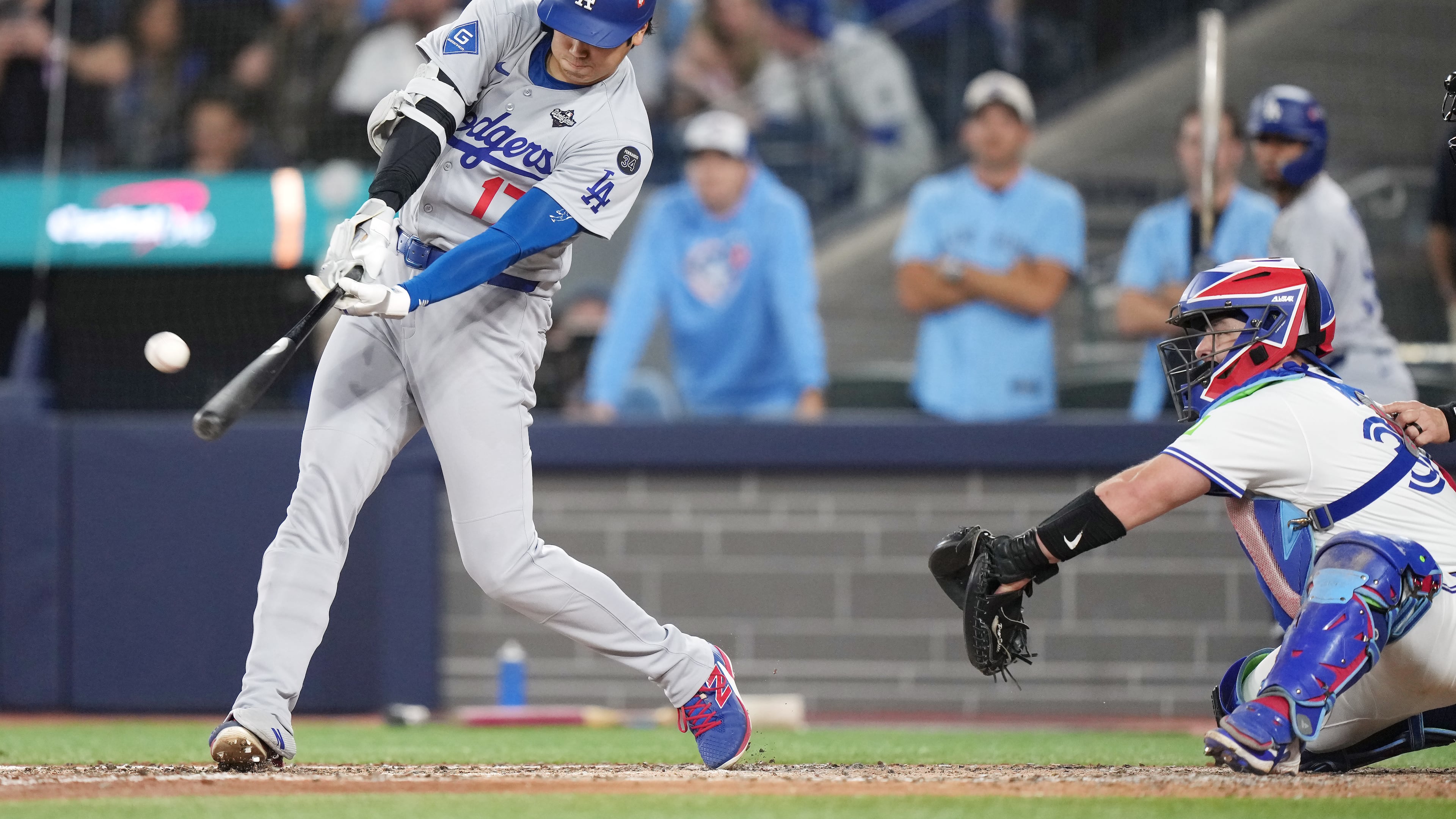 Los Angeles Dodgers' Shohei Ohtani (17) hits a two-run home run against the Toronto Blue Jays during the sixth inning in Game 1 of baseball's World Series, Friday, Oct. 24, 2025, in Toronto. (Nathan Denette/The Canadian Press via AP)