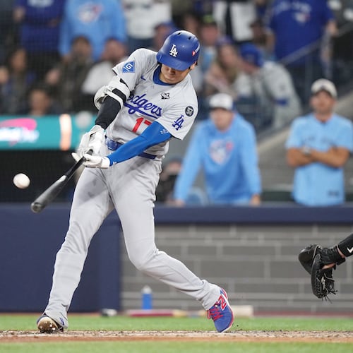 Los Angeles Dodgers' Shohei Ohtani (17) hits a two-run home run against the Toronto Blue Jays during the sixth inning in Game 1 of baseball's World Series, Friday, Oct. 24, 2025, in Toronto. (Nathan Denette/The Canadian Press via AP)