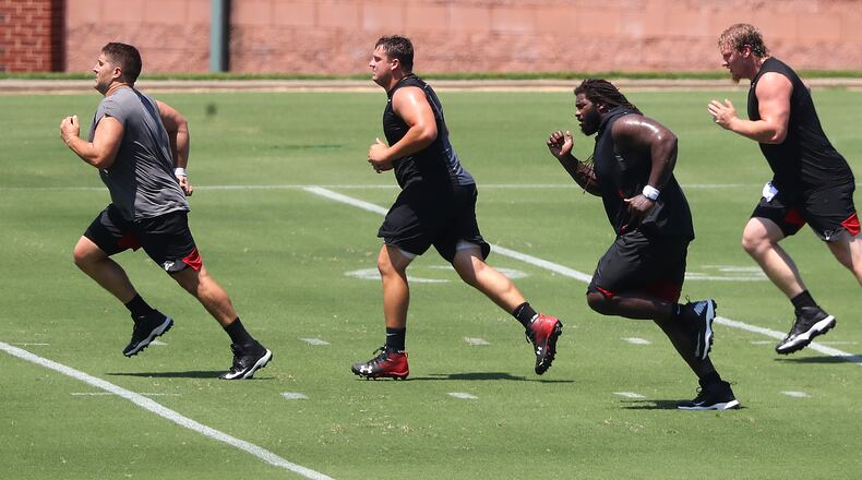 080420 Flowery Branch: Atlanta Falcons offensive lineman Alex Mack (from left), Chris Lindstrom, James Carpenter, and Kaleb McGary run sprints during a team strength and conditioning workout on Tuesday, August 4, 2020 in Flowery Branch.    Curtis Compton ccompton@ajc.com