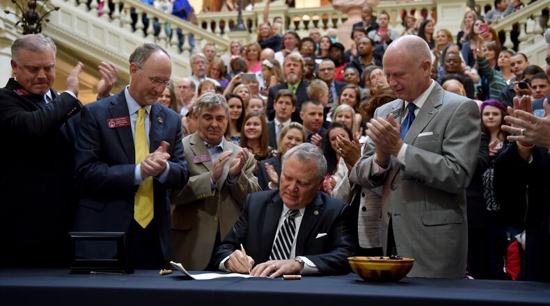 April 16, 2015 Atlanta, GA: Gov. Nathan Deal signs House Bill 1 Thursday amid a crowd of supporters. The bill now allows the limited use of cannabis oil to treat disorders that include cancer, sickle cell disease and epilepsy as long as a physician signs off. BRANT SANDERLIN/BSANDERLIN@AJC.COM