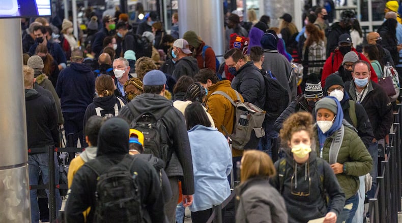 A crowd goes through security at Atlanta's Hartsfield-Jackson International Airport on Saturday, January 29, 2022. Atlanta-based Delta Air Lines suspended operations at its hubs in New York and Boston on Saturday and canceled more than 1,000 flights through the weekend due to the nor’easter expected to hit the region. STEVE SCHAEFER FOR THE ATLANTA JOURNAL-CONSTITUTION