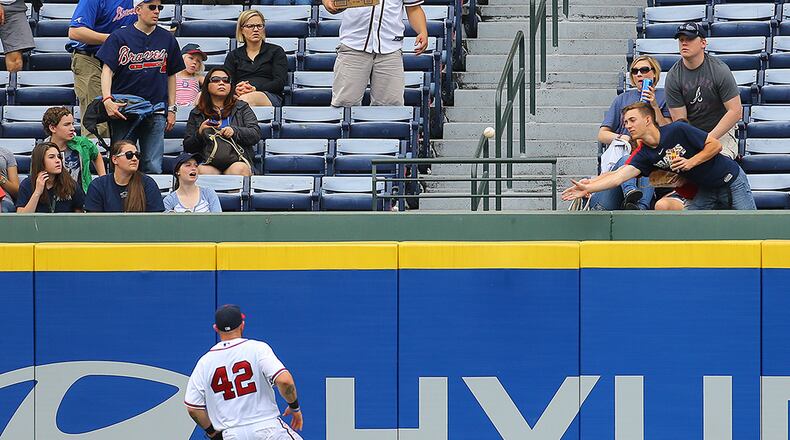 Braves outfielder Jonny Gomes can't get to a 2-run homer by Marlins Adeiny Hechavarria, which gave Miami a 4-0 lead over the Braves in the fifth inning Wednesday, April 15, 2015, in Atlanta.