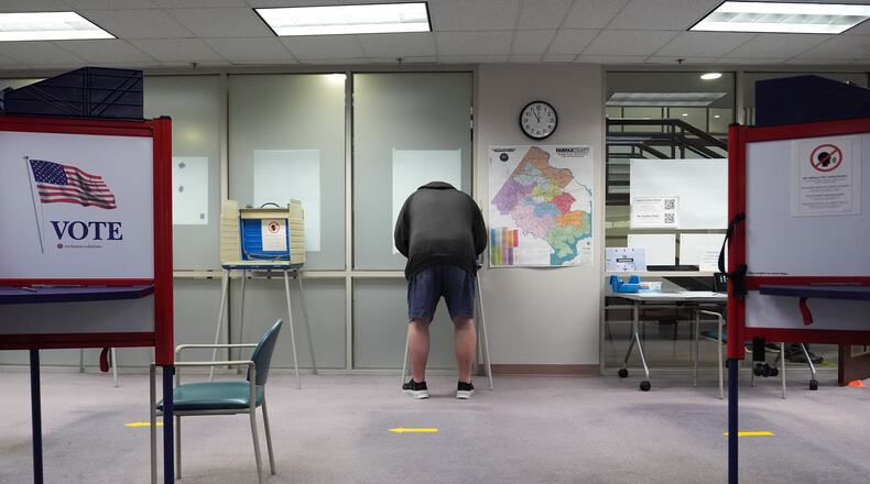 A person early votes in the Virginia redistricting referendum at the Fairfax County Government Center, Friday, April 3, 2026, in Fairfax, Va. (AP Photo/Julia Demaree Nikhinson)