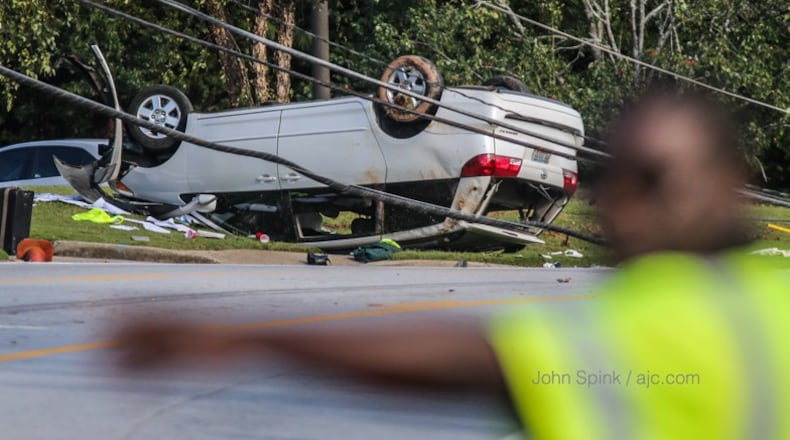 A crash knocked down a utility pole in front of Georgia Piedmont Technical College in DeKalb County on Monday. (JOHN SPINK / JSPINK@AJC.COM)