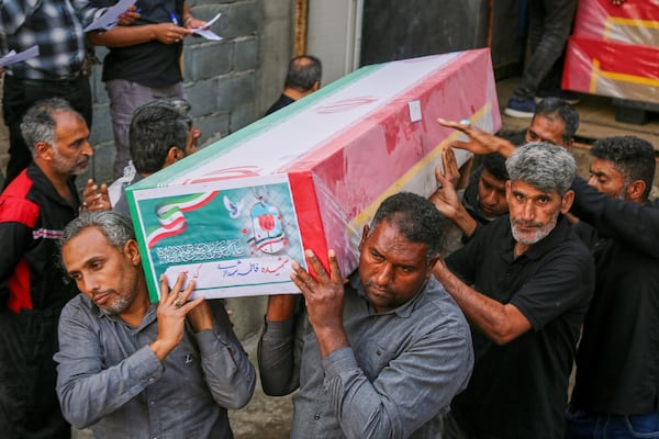A coffin is carried during the funeral of mostly children killed in what Iranian officials said was an Israeli-U.S. strike at a girls’ elementary school in Minab, Iran, on Tuesday, March 3, 2026. (Abbas Zakeri/Mehr News Agency via AP)